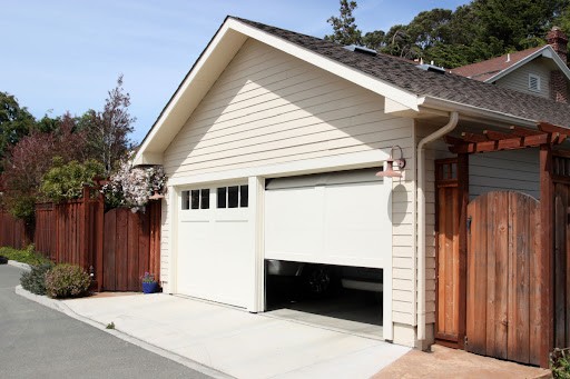 Two residenial garage doors where one is closed and one is partially open.
