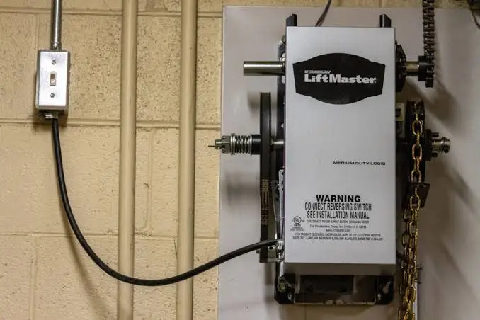 LiftMaster garage door opener motor and wall switch used for garage door programming